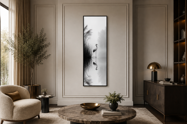 Tall narrow black and white Japanese crane wall art in a zen-style living room.