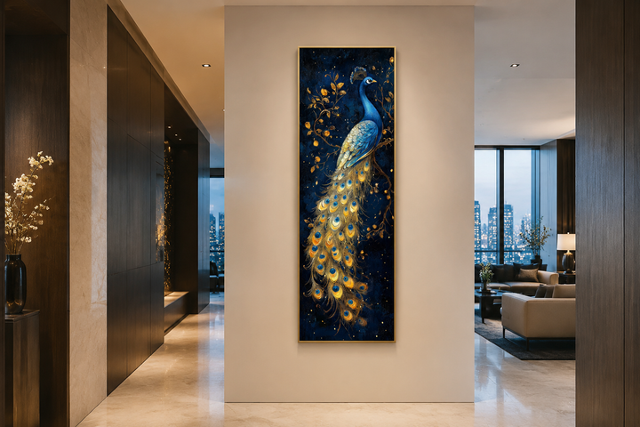 Tall narrow framed canvas wall art of a blue and gold peacock on a deep navy background.