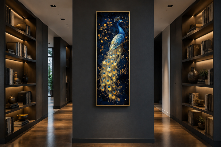 Blue and gold peacock canvas wall art in a tall narrow frame hanging on a dark gray wall.