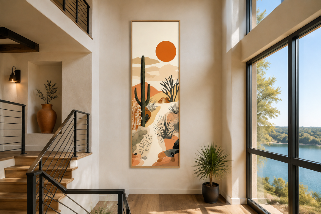Tall narrow framed canvas wall art featuring a desert cactus landscape under a burnt orange sun.