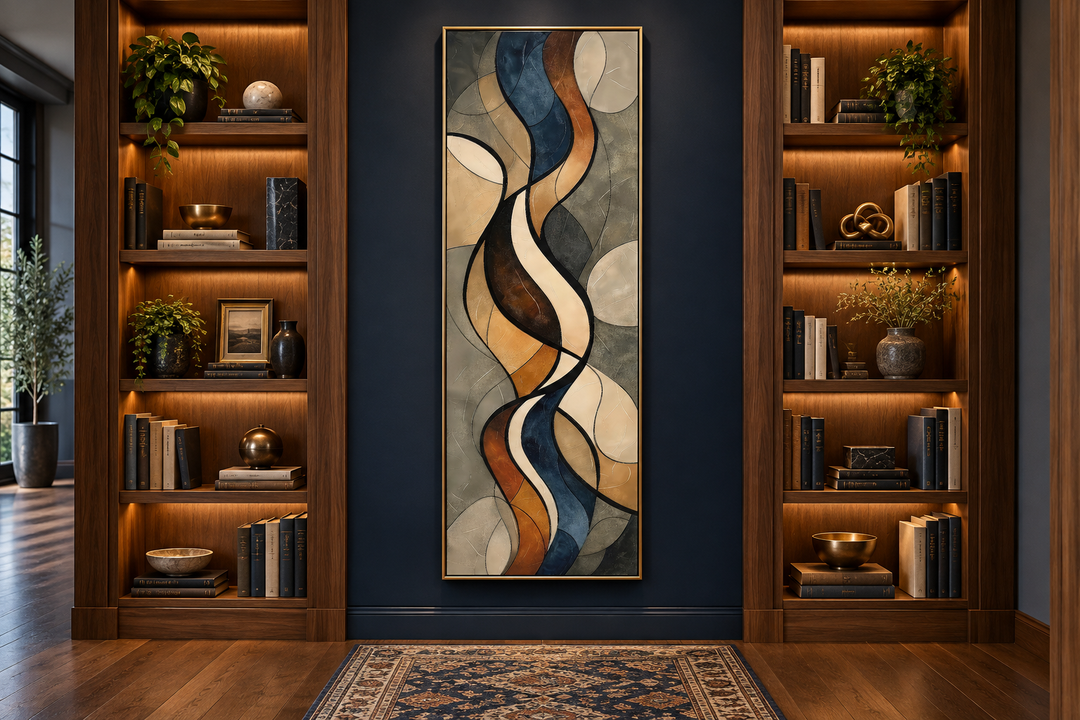Tall narrow framed canvas wall art with abstract flowing shapes in earth tones on a dark blue wall.