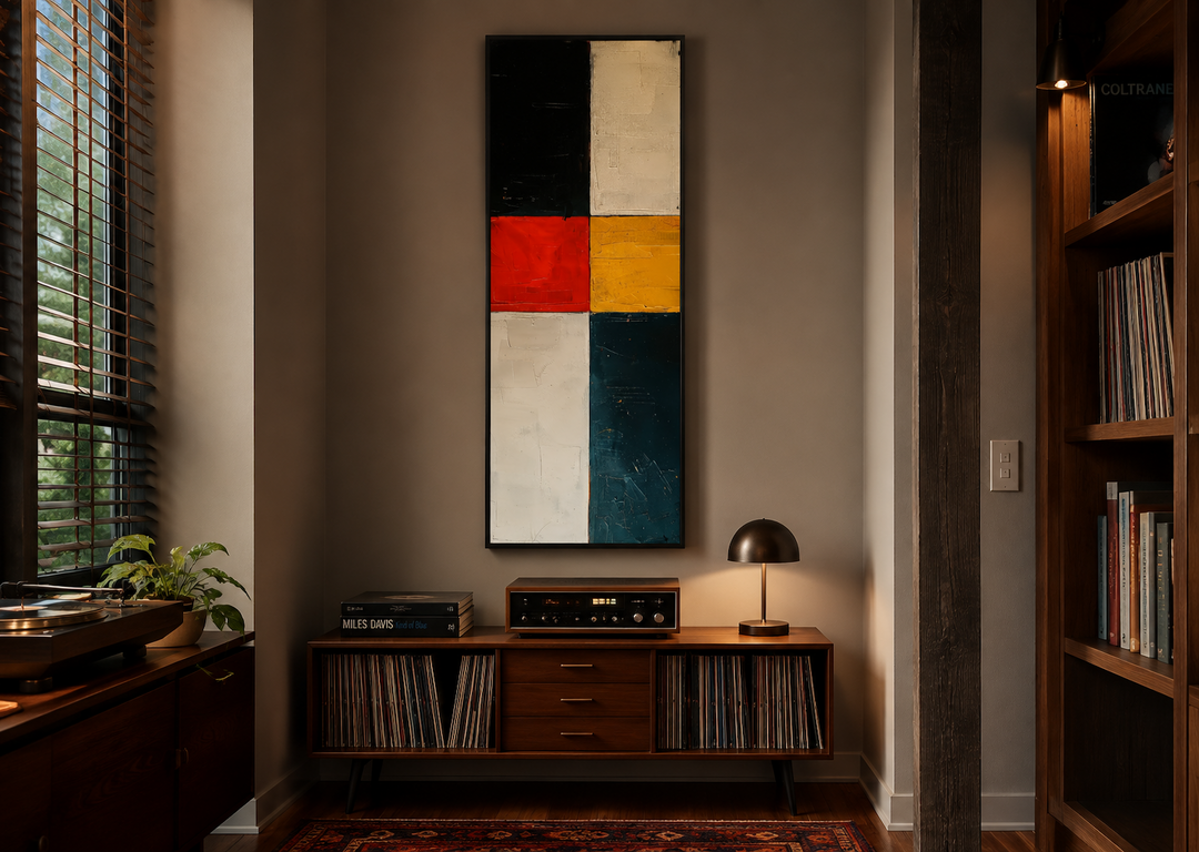Tall narrow vertical canvas print with bold geometric blocks in black, white, red, and yellow.