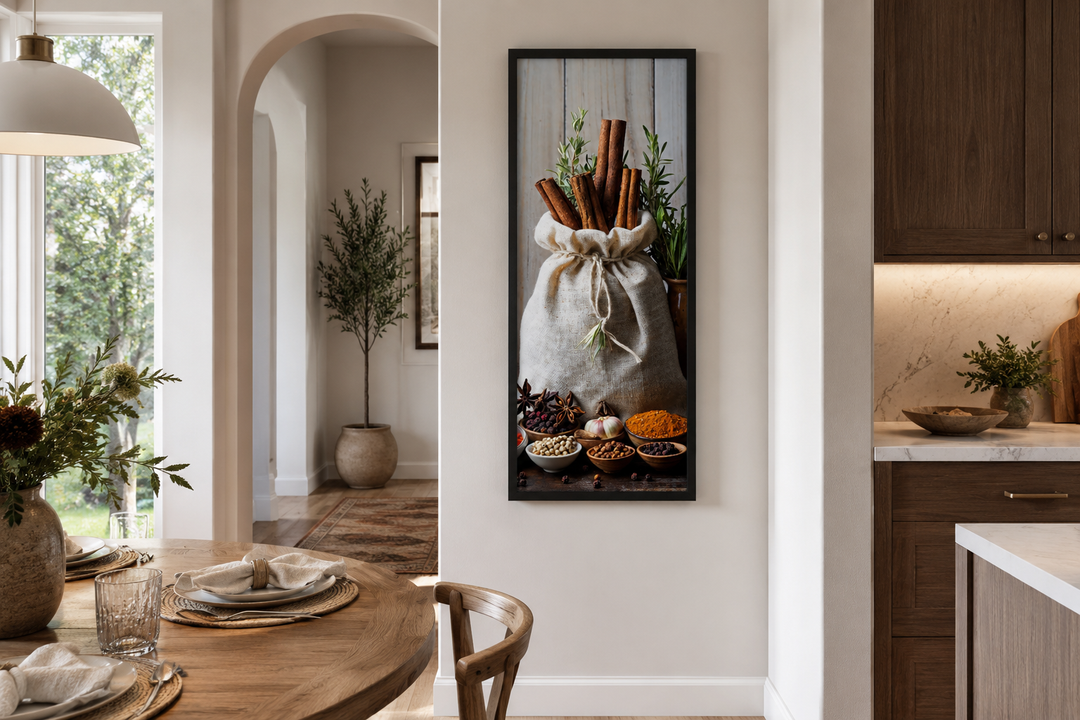 Tall narrow vertical framed canvas wall art of herbs and spices in a sack on a kitchen wall.