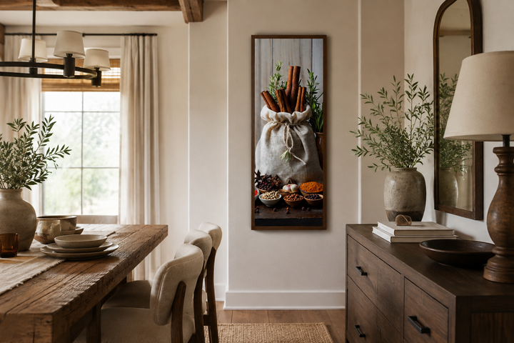 Tall narrow vertical framed canvas wall art of herbs and spices in a rustic kitchen setting.