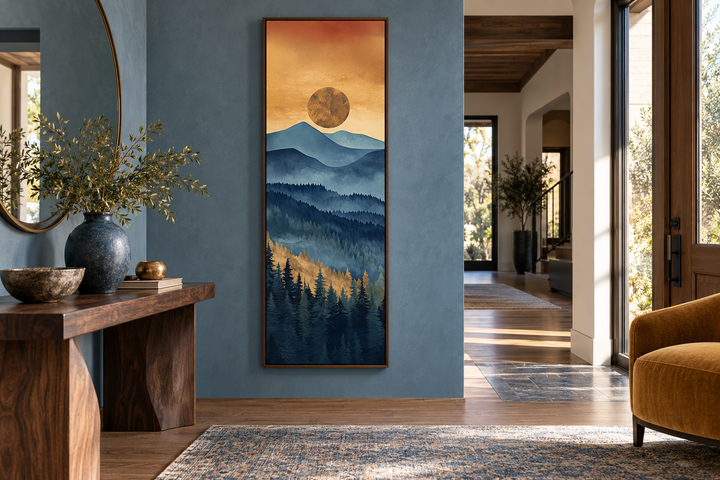 Tall narrow vertical canvas art of a mountain sunset with blue peaks and a golden sun in a foyer.