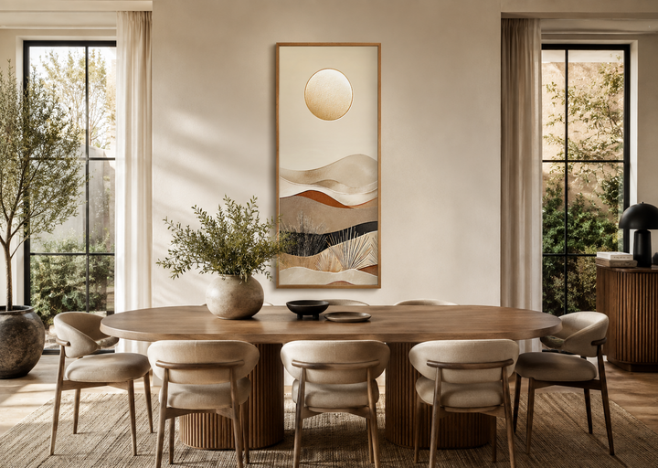Tall narrow boho desert and sun canvas vertical wall art hanging above a wooden dining table.