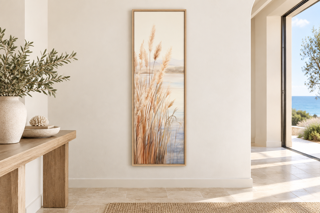 Vertical framed canvas art of pampas grass on a beach in neutral beige and sandy tones.