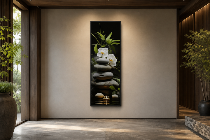 Tall narrow vertical canvas art of stacked zen rocks, white orchids, and bamboo on a neutral wall.