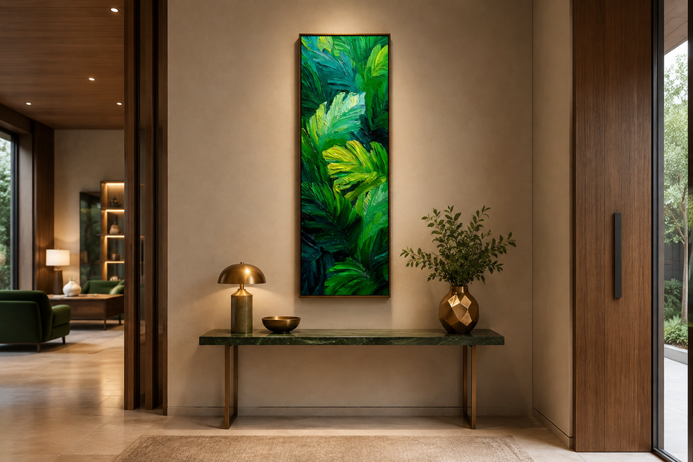 Vertical canvas print of lush green tropical leaves in a painterly style above a console table.
