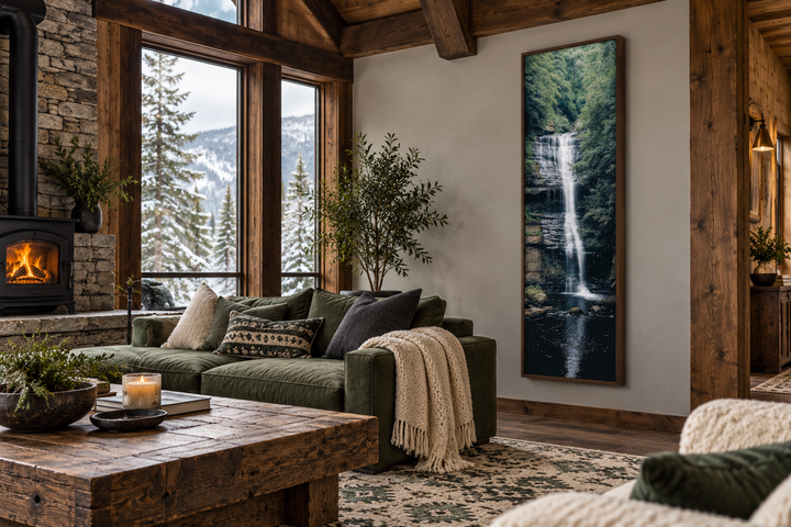 Tall narrow vertical framed canvas wall art of a serene waterfall in a rustic mountain cabin.