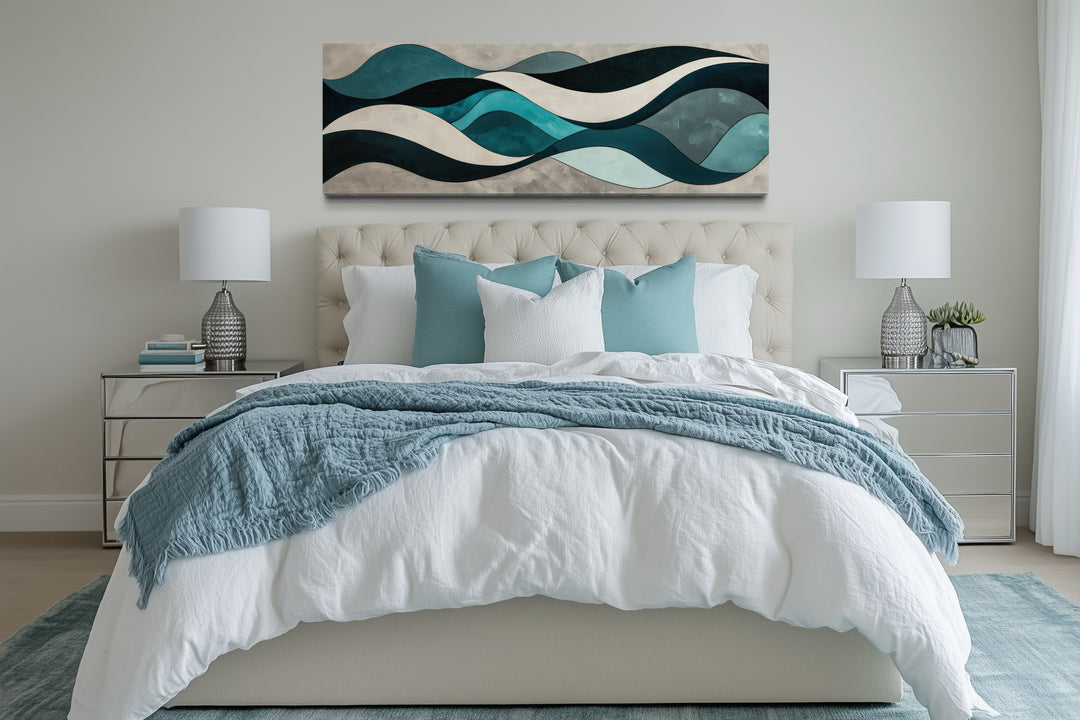 Teal blue and grey abstract waves horizontal wall art hanging above a bed in a modern bedroom.