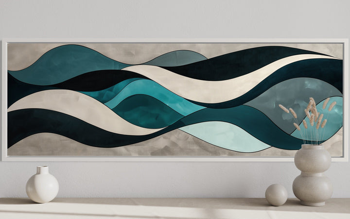 Long horizontal wall art with teal, blue, and grey abstract waves in a white frame.