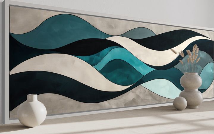 Long horizontal wall art featuring abstract teal, blue, and grey waves in a modern frame.