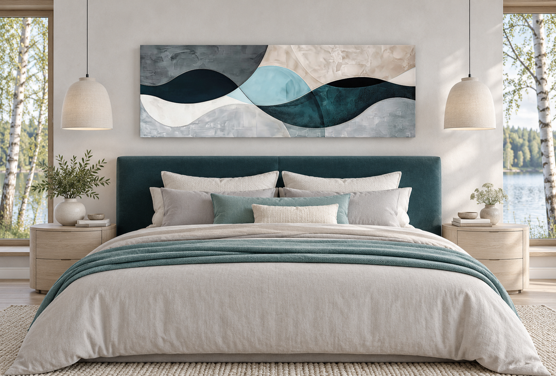 Long horizontal abstract geometric wall art in teal, blue, and grey above a bed in a modern bedroom.