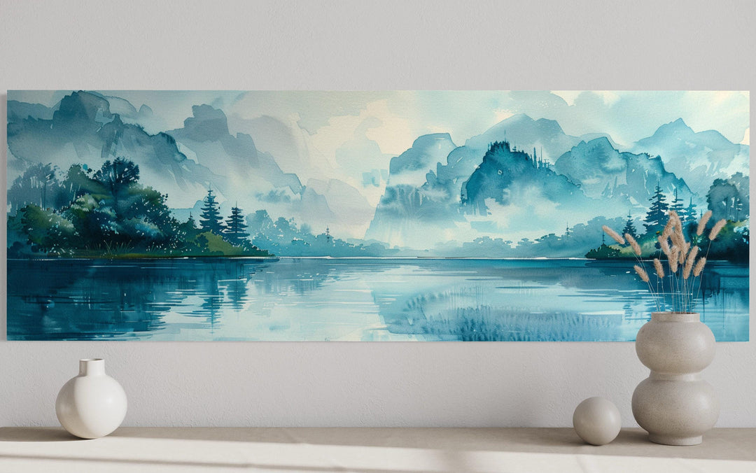 Teal mountain lake horizontal canvas wall art featuring a misty watercolor landscape above a shelf.