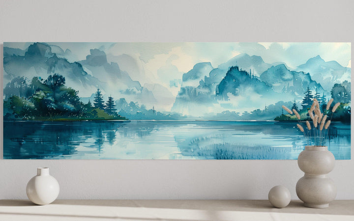 Teal mountain lake horizontal canvas wall art featuring a misty watercolor landscape above a shelf.