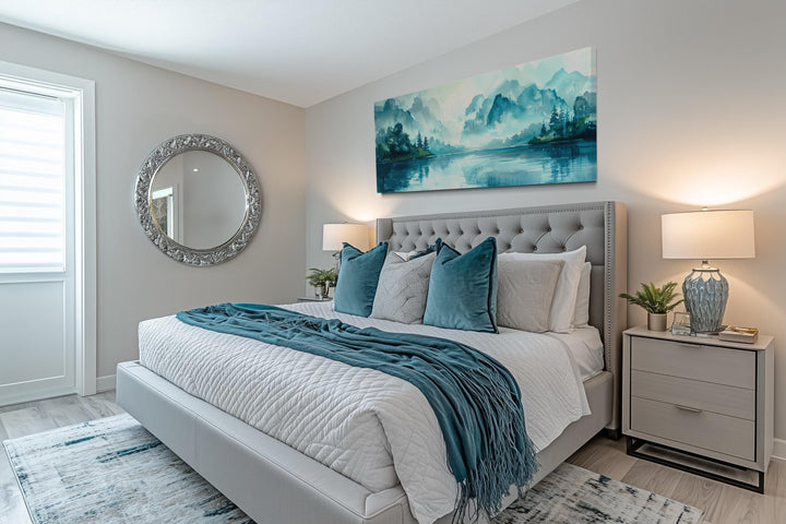 Teal mountain lake horizontal canvas wall art hanging above a tufted grey bed in a modern bedroom.