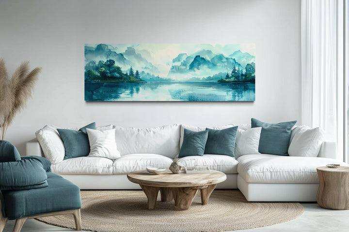 Teal Mountain Lake Horizontal Canvas Wall Art above a white sectional sofa in a modern living room.