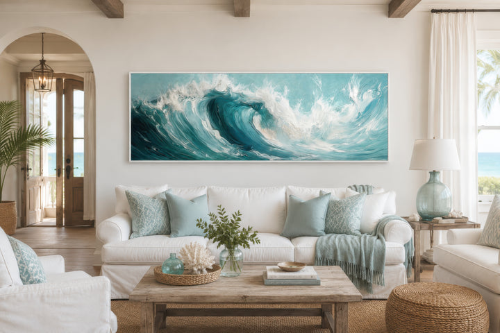 Teal Ocean Wave Coastal Horizontal Framed Canvas Wall Art hanging above a white sofa.
