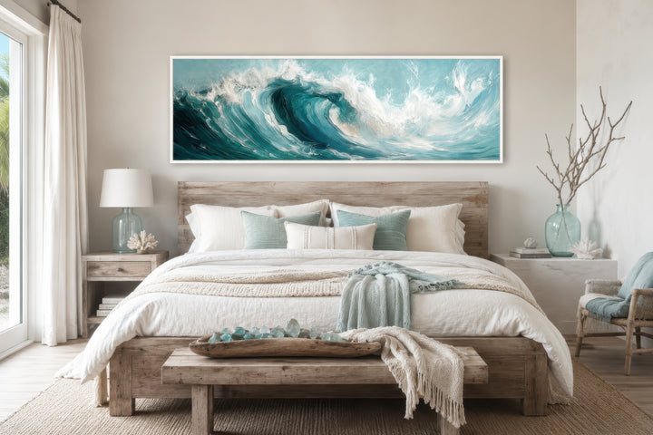 Teal Ocean Wave Coastal Horizontal Framed Canvas Wall Art hanging above a bed in a coastal bedroom.