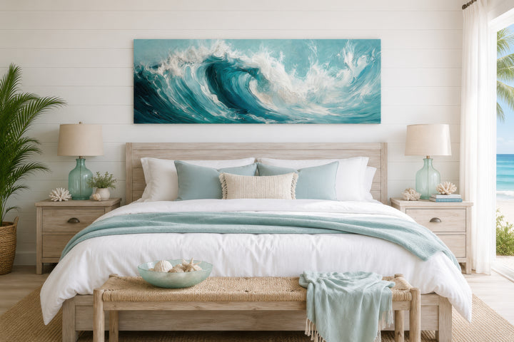 Teal ocean wave coastal horizontal framed canvas wall art hanging above a bed in a beachy bedroom.