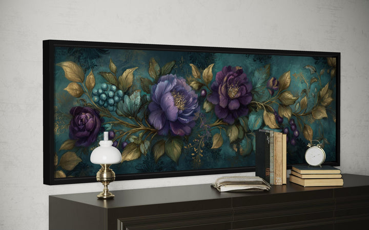 Teal and purple peony wall art with gold leaf accents in a black frame above a dark wood dresser.
