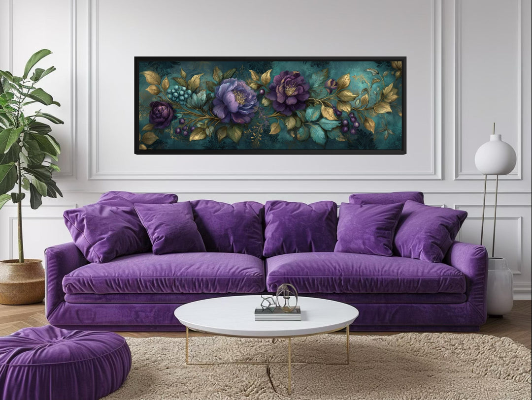 Teal and purple peony wall art with gold leaf accents in a black frame above a purple velvet sofa.