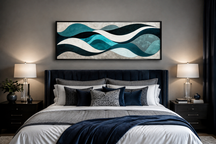 Teal, blue, and grey abstract waves long horizontal wall art framed above a bed in a bedroom.