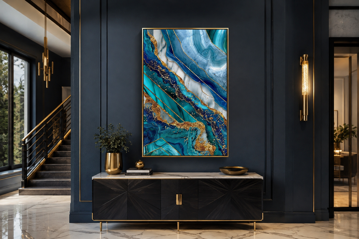 Teal and gold abstract marble framed canvas wall art hanging above a black console table.