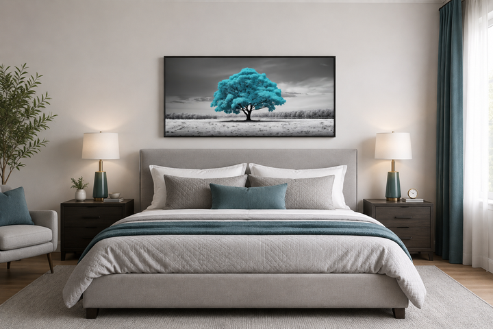 Teal tree on black and white background framed canvas wall art hanging above a gray bed.