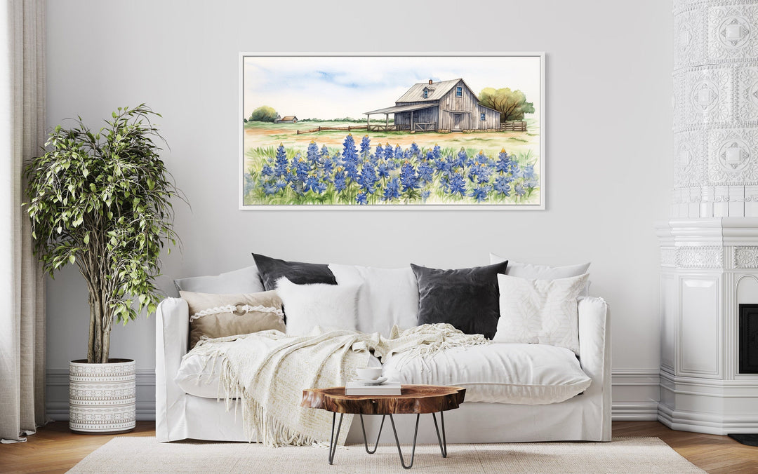 Texas Barn Wall Art canvas print featuring a rustic barn and bluebonnet field over a white sofa.