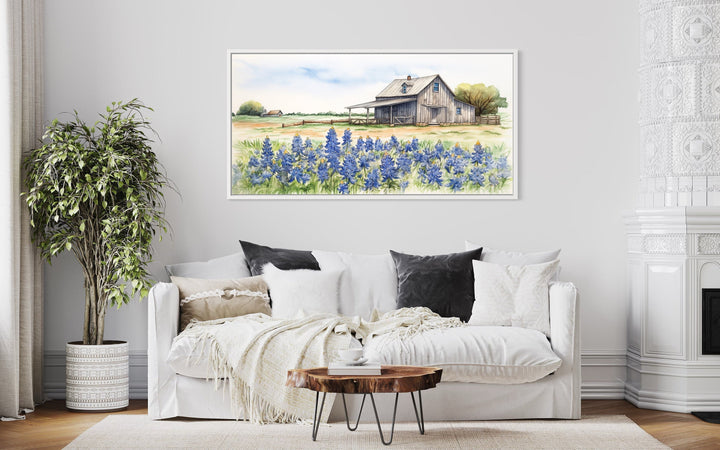 Texas Barn Wall Art canvas print featuring a rustic barn and bluebonnet field over a white sofa.