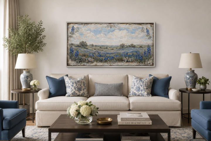 Texas Bluebonnet wall art canvas print in a vintage landscape style above a cream sofa.