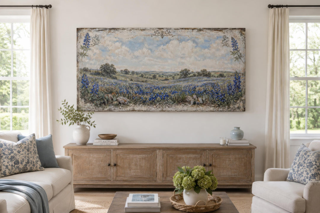 Vintage Texas bluebonnet landscape canvas print hanging above a wooden console in a bright room.