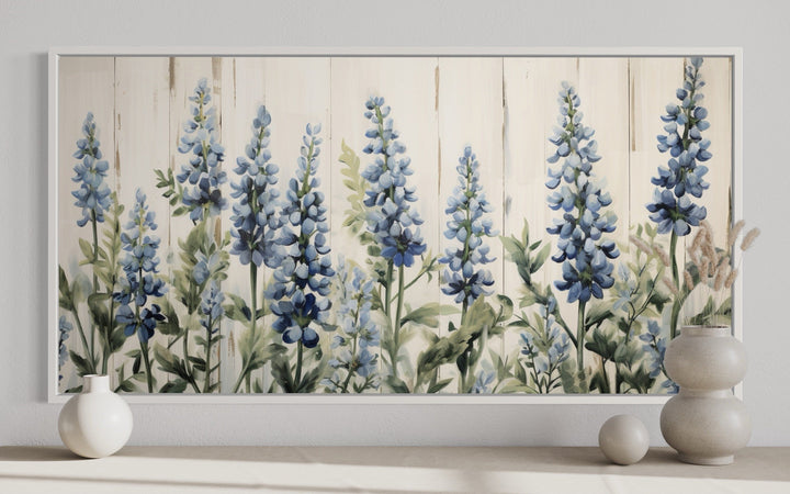 Texas Bluebonnets painted on wood rustic framed canvas wall art above a neutral console table.