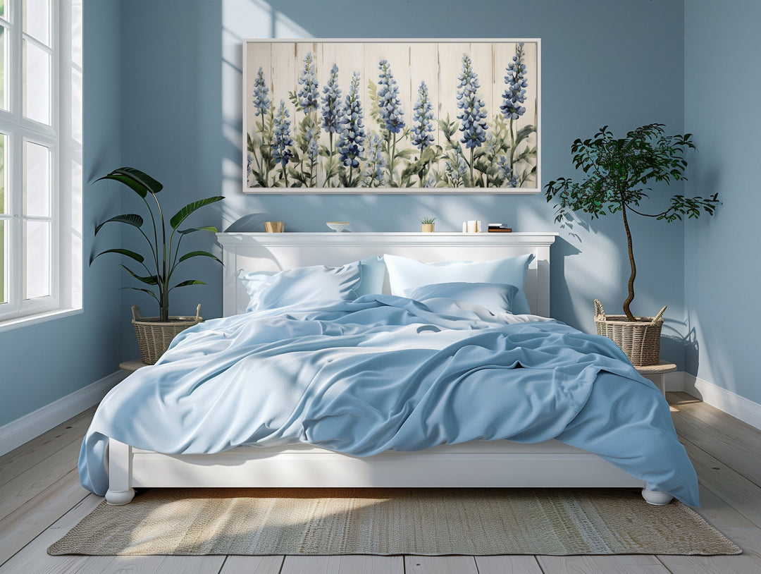 Texas Bluebonnets painted on wood rustic framed canvas wall art hanging above a white bed.