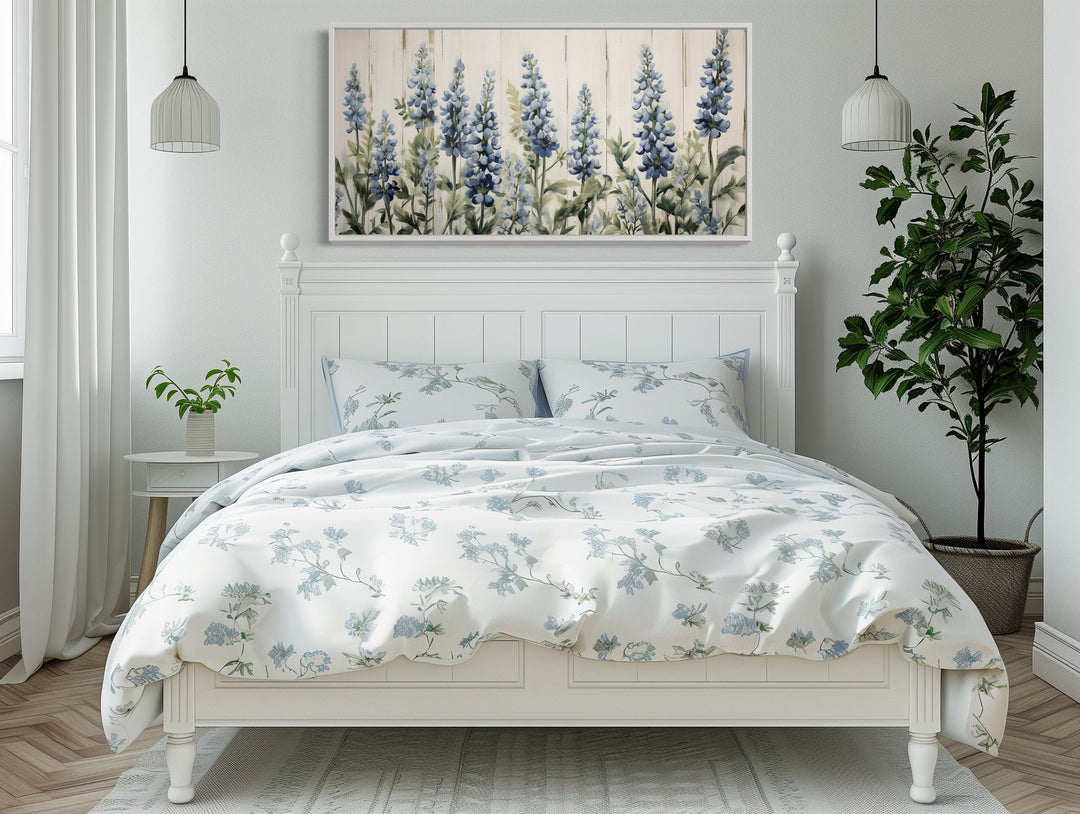 Texas Bluebonnets painted on wood rustic framed canvas wall art hanging above a white bed.
