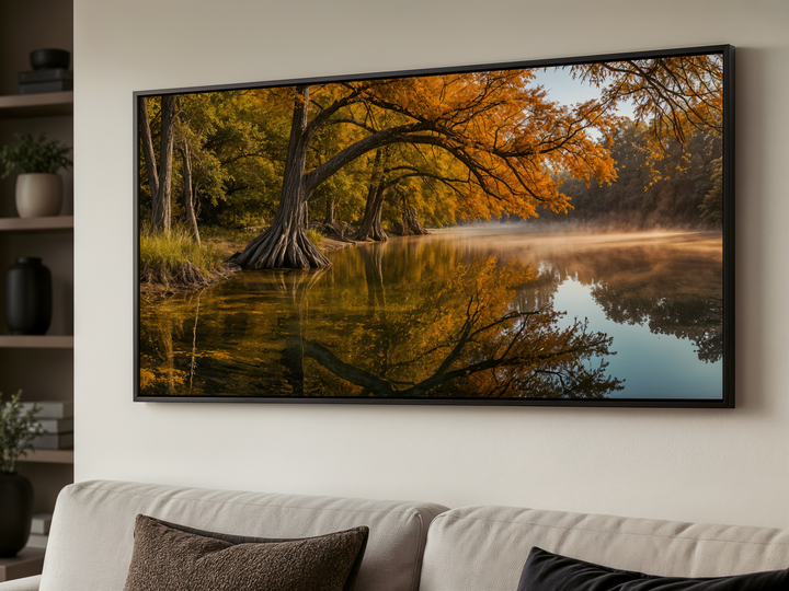 Framed Texas landscape wall art featuring a vibrant fall river scene above a modern sofa.