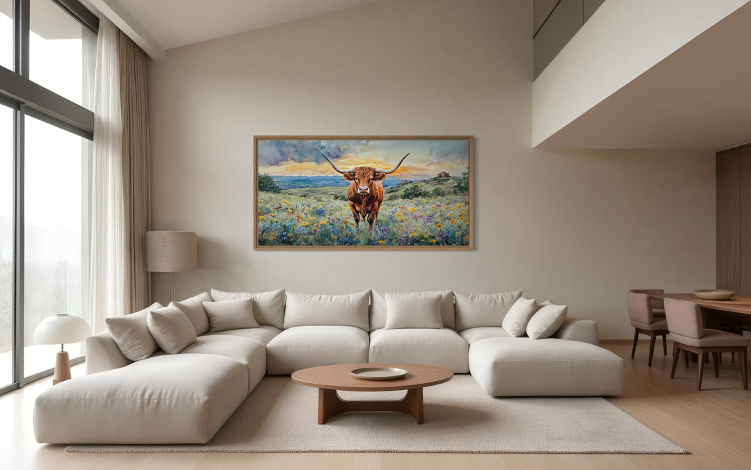 Framed canvas wall art of a Texas Longhorn cow in a wildflower field.