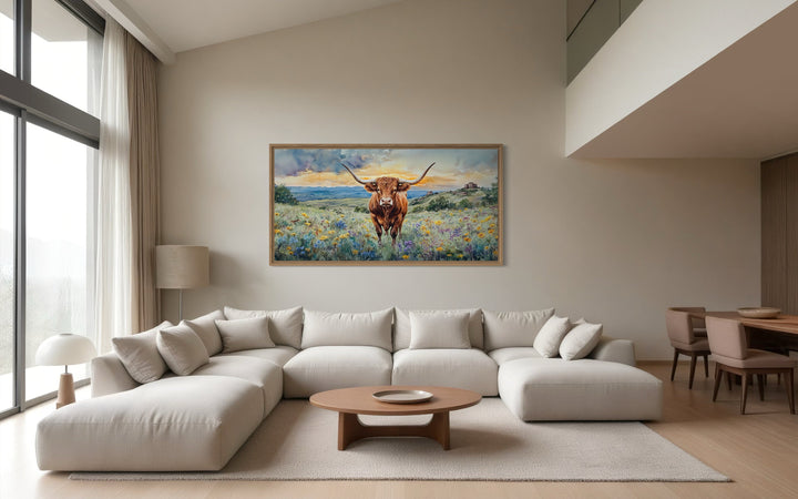 Framed canvas wall art of a Texas Longhorn cow in a wildflower field.