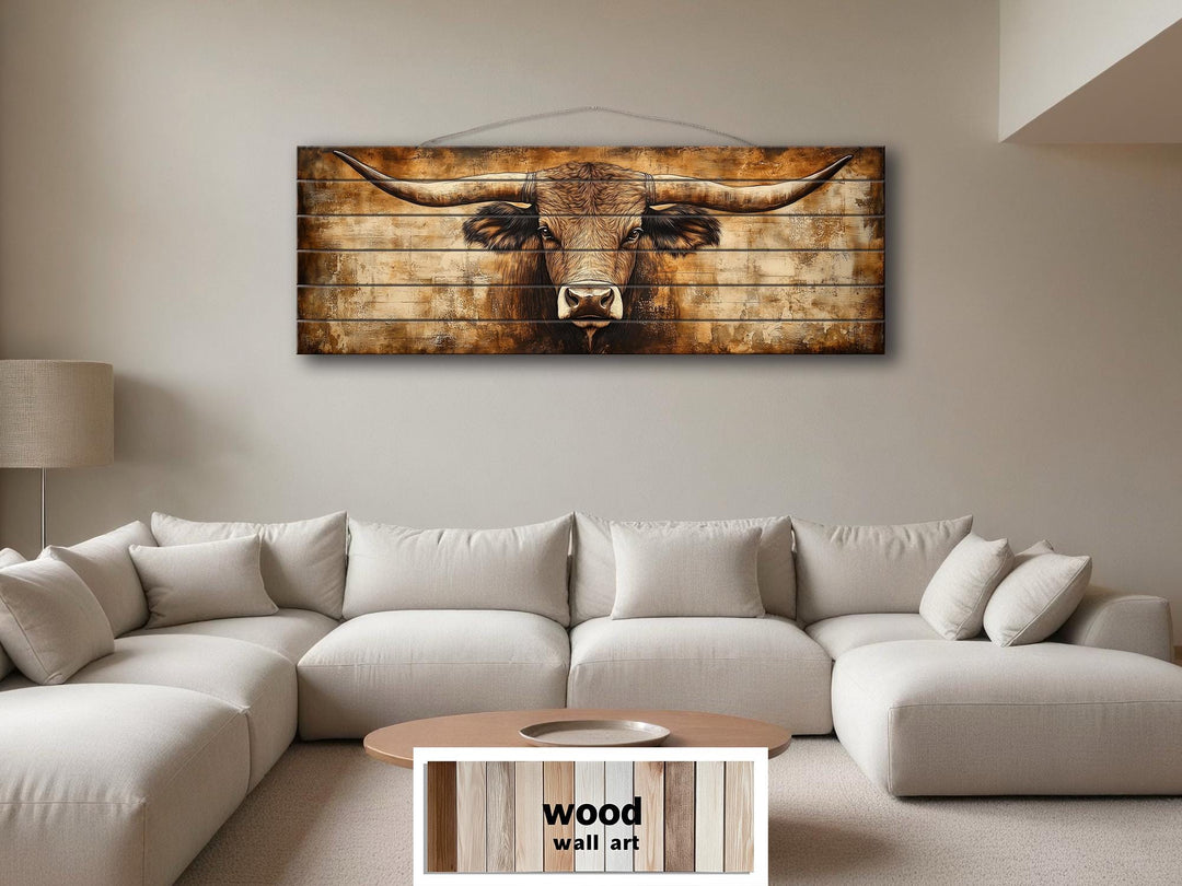 Texas longhorn horizontal wood wall art hanging above a modern neutral-toned sectional sofa.