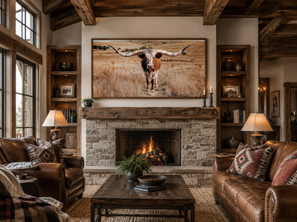 Texas Longhorn photography framed canvas wall art above a stone fireplace in a rustic living room.