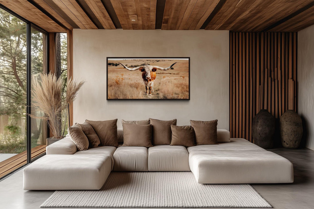 Texas Longhorn bull photography framed canvas wall art in a modern rustic living room.
