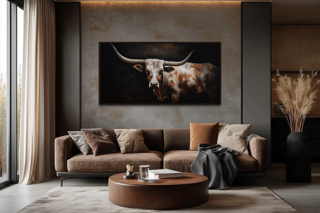 Extra-large framed canvas wall art of a Texas Longhorn cow in a rustic, modern living room.
