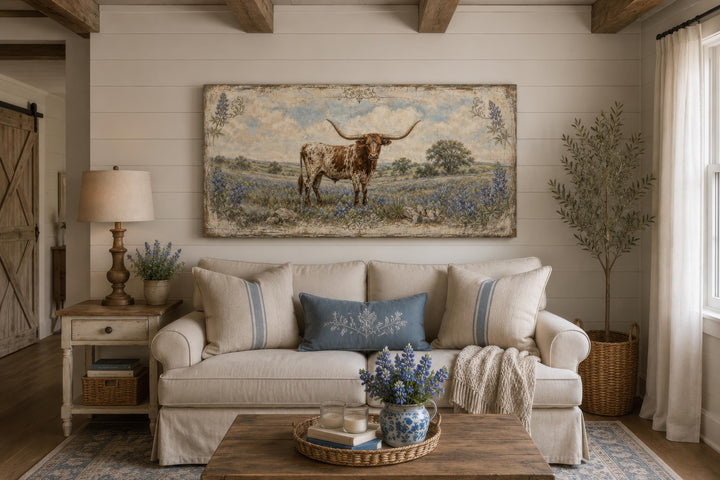 Rustic Texas Longhorn canvas wall art featuring bluebonnets above a farmhouse sofa.