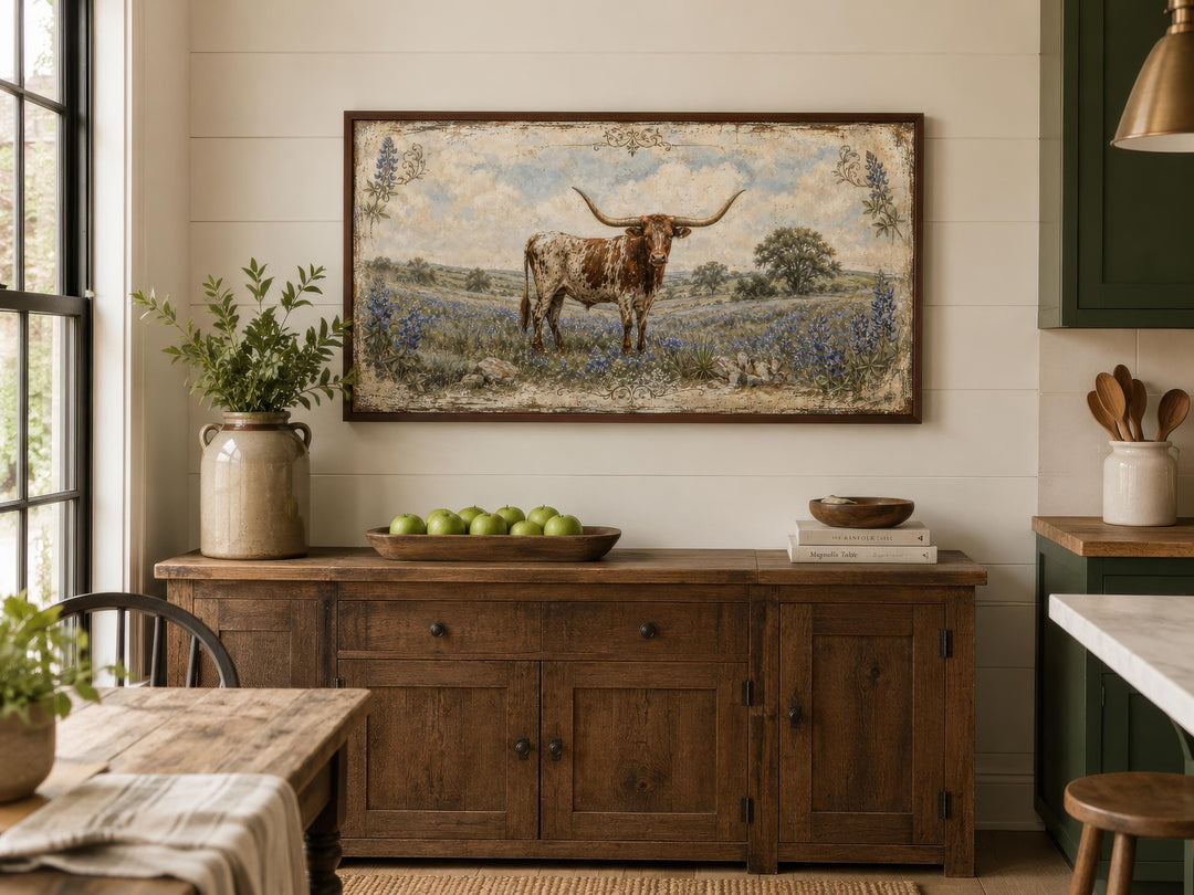 Texas Longhorn canvas print in a rustic frame above a wooden sideboard in a farmhouse dining room.