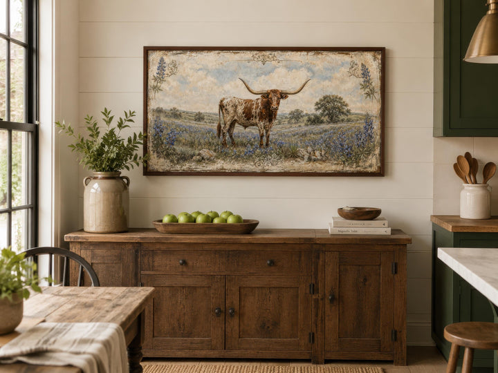 Texas Longhorn canvas print in a rustic frame above a wooden sideboard in a farmhouse dining room.