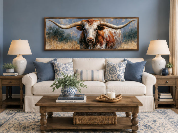 Texas Longhorn wall art in a long narrow frame above a white sofa in a farmhouse living room.