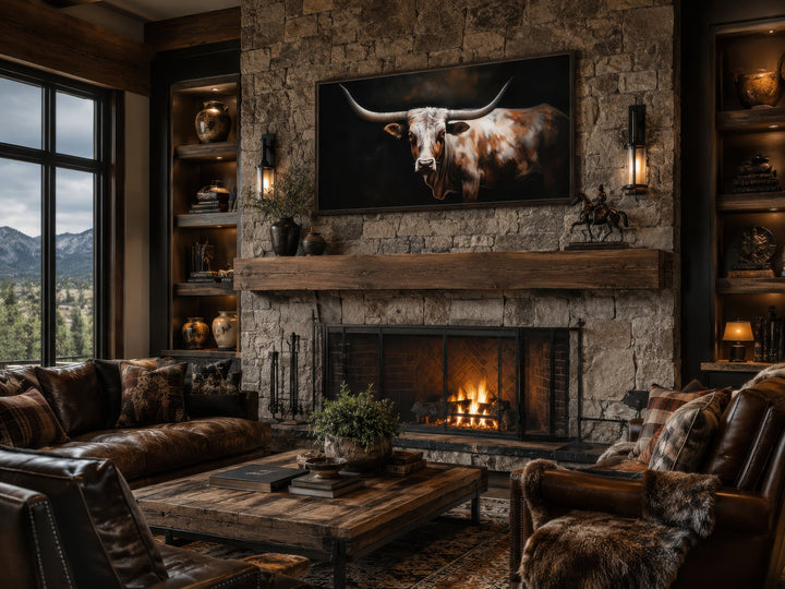 Extra large framed canvas wall art of a Texas Longhorn cow above a rustic stone fireplace.