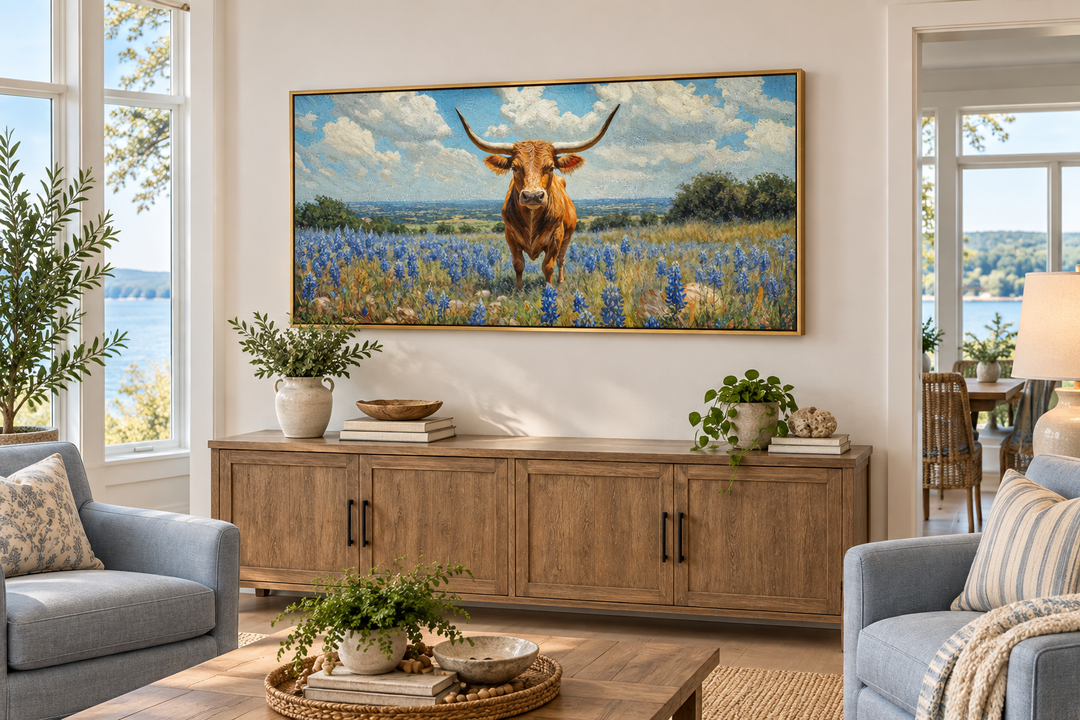 Texas longhorn cow in bluebonnets field framed canvas wall art above a wooden sideboard.